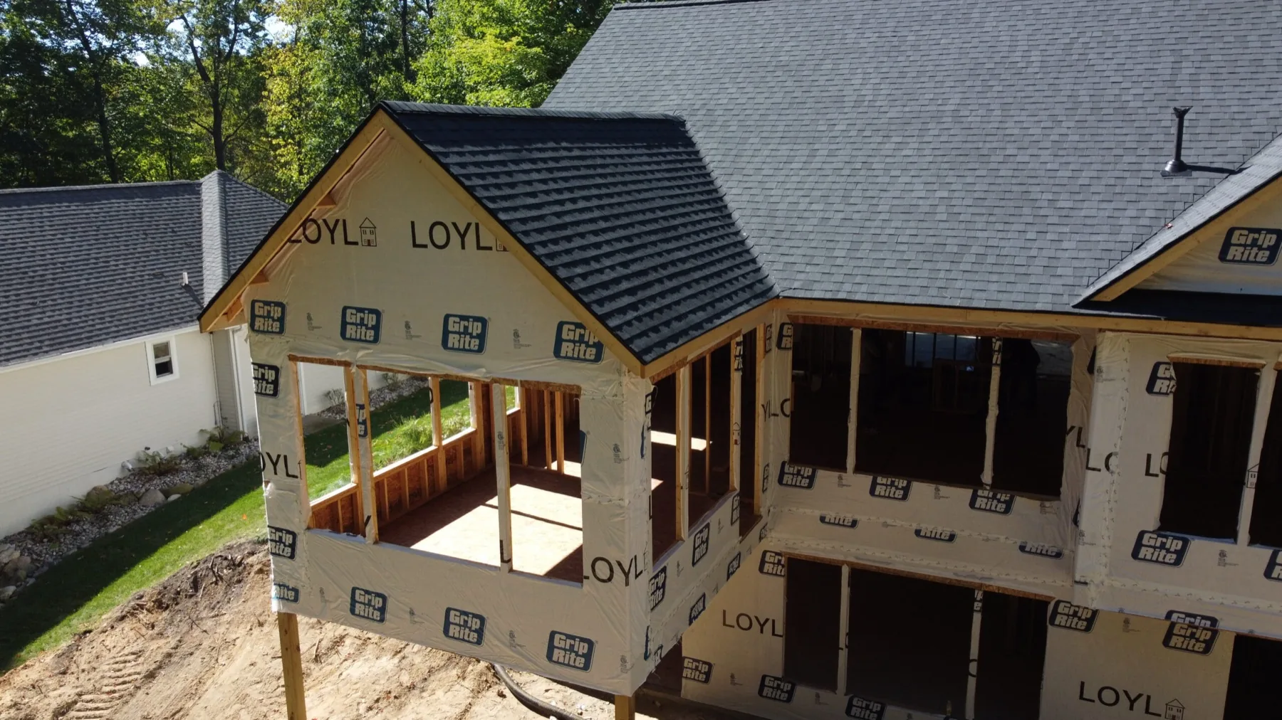A LOYL Construction home under construction, sheathed and roofed